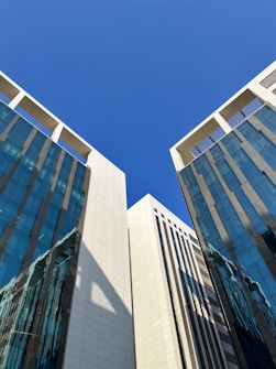 a couple of tall buildings sitting next to each other