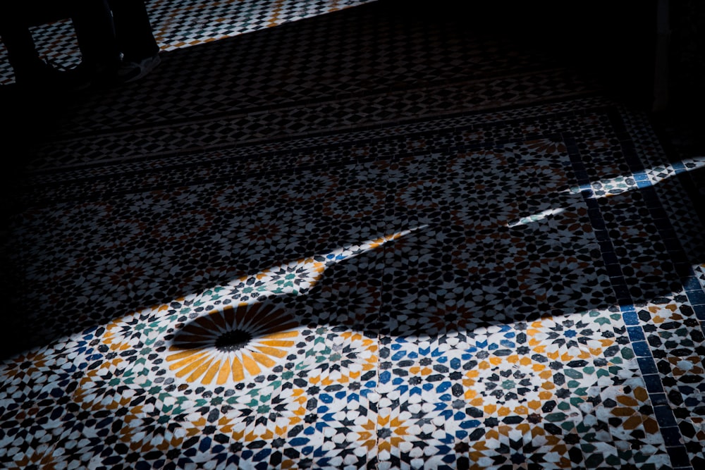 a black and white tiled floor with a fan on it