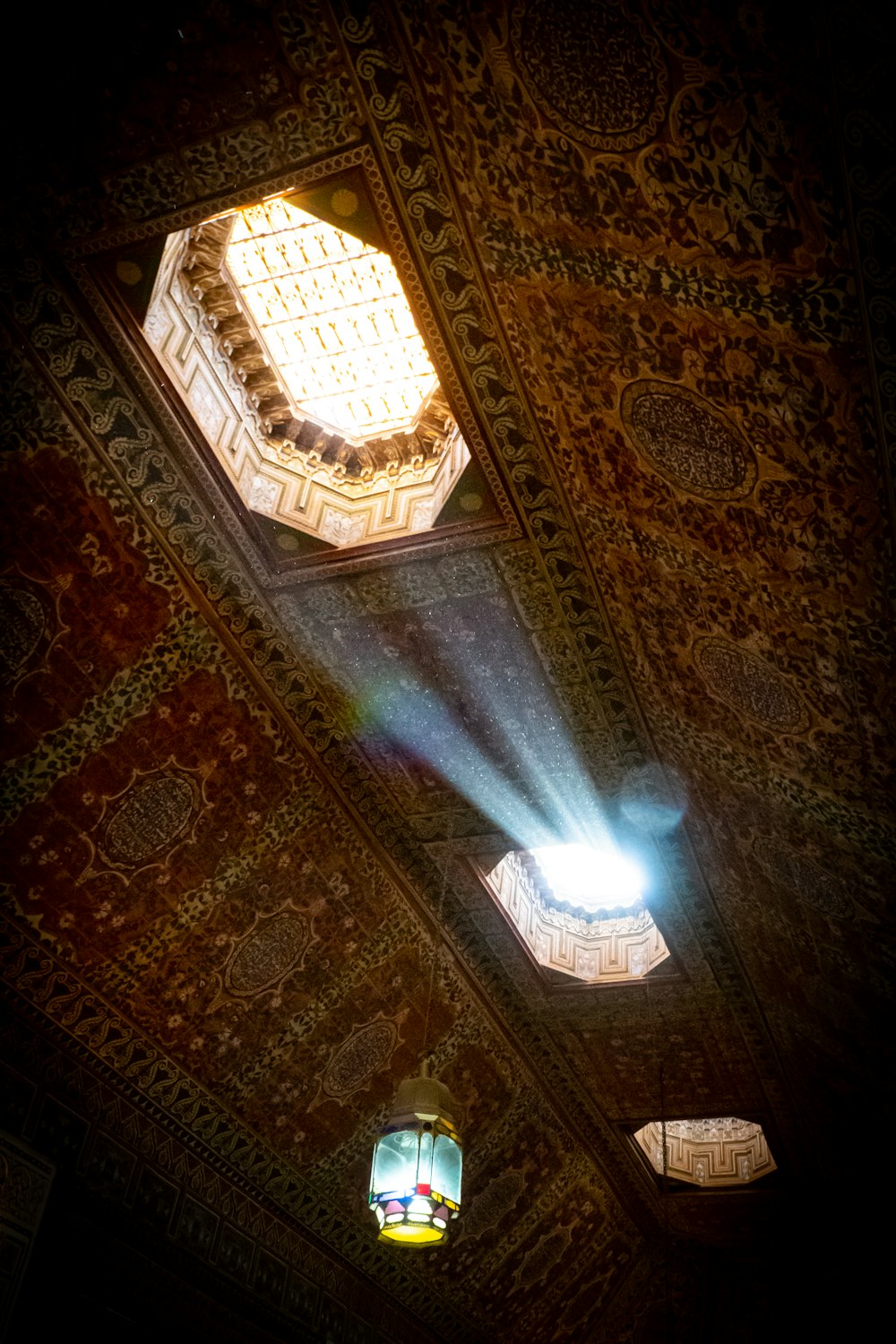 a light shines through the ceiling of a building