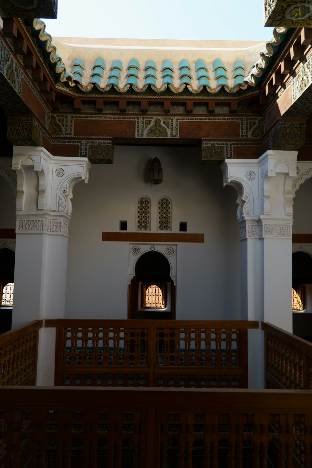 a building with a balcony and a clock on the wall