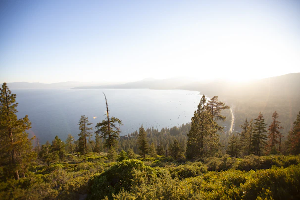 Scenic shot of nearby attractions including rolling hills and sparkling waters of Lake Travis at golden hour.