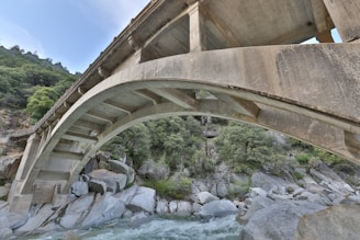 Robust concrete bridge under construction over a river