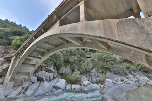 Robust concrete bridge under construction over a river