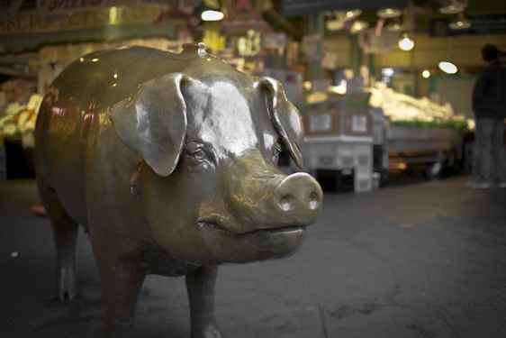 A farmer checking pig prices in a vibrant Vietnamese market.