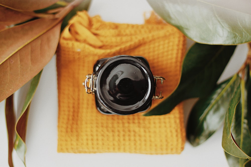 a camera sitting on top of a yellow towel