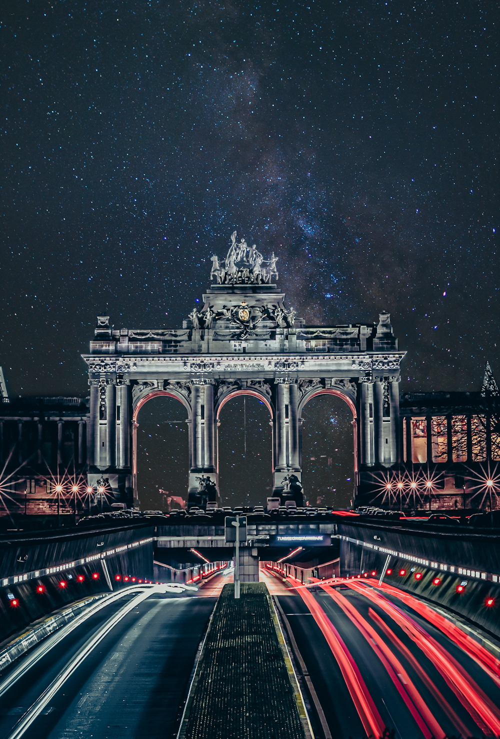 a night time view of a city with a clock tower