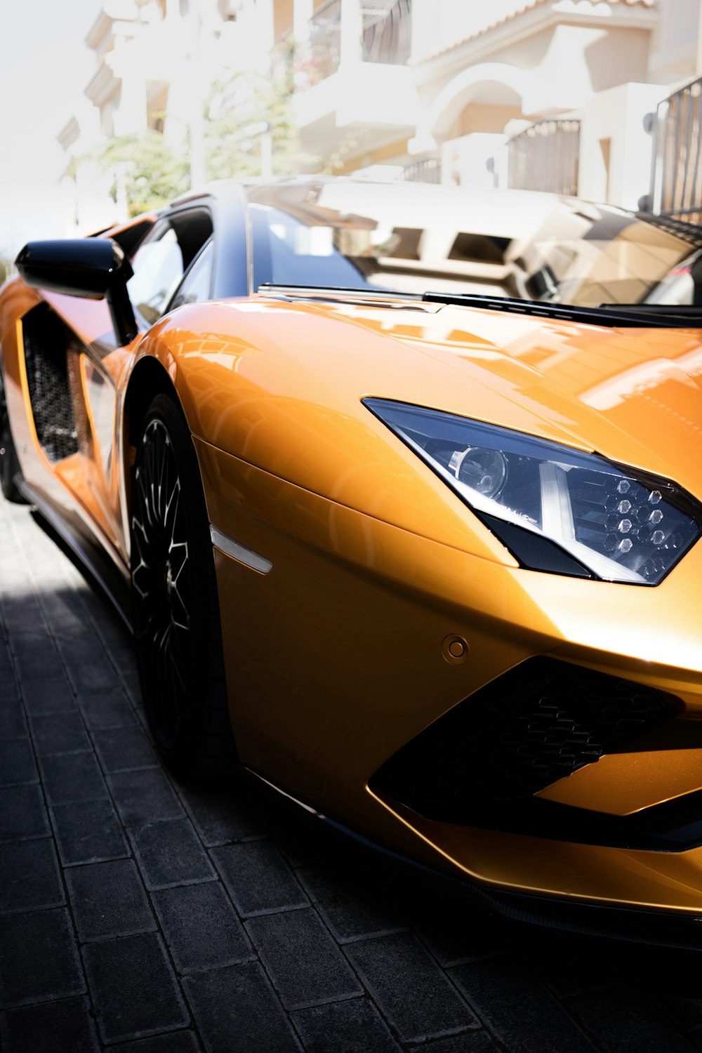 a yellow sports car parked on the side of the road