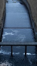 a large body of water with a bridge over it