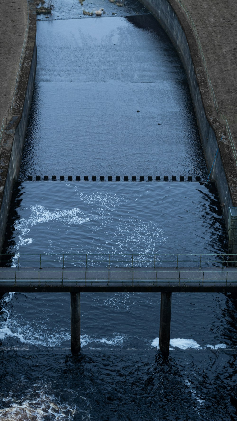 a large body of water with a bridge over it