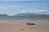 A serene beach scene with hydrofoil boards resting on the sand.