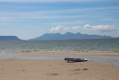 A serene beach scene with hydrofoil boards resting on the sand.