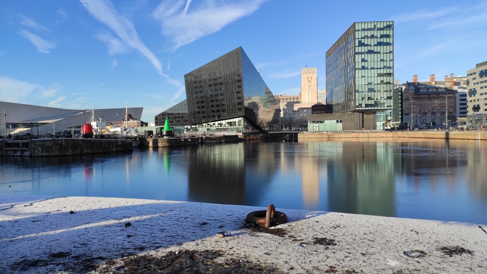 a body of water with buildings in the background