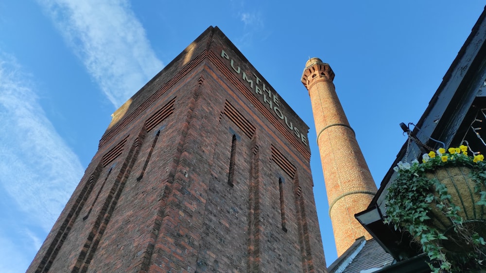 a tall brick building next to a tall brick tower