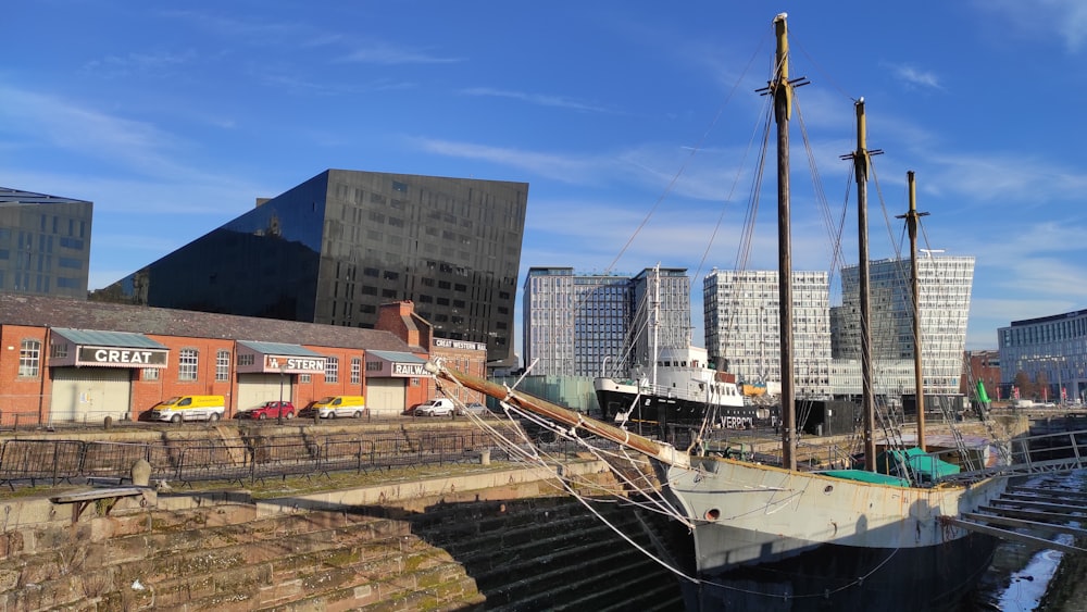 a boat is docked at a dock in a city