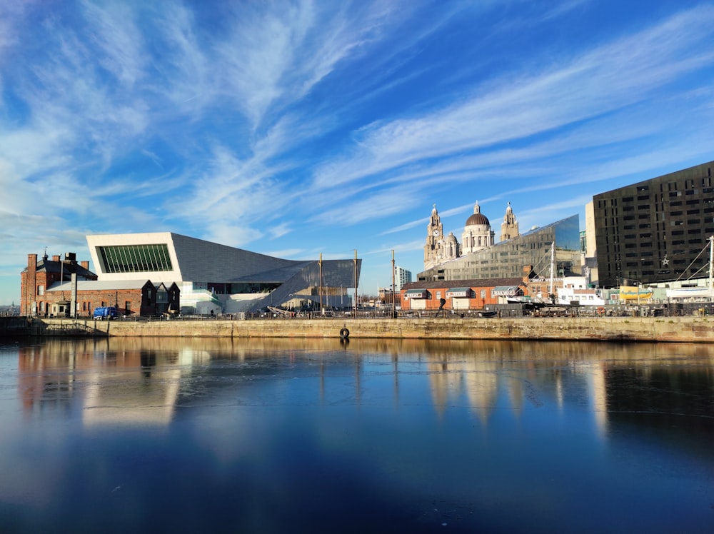 a body of water with buildings in the background