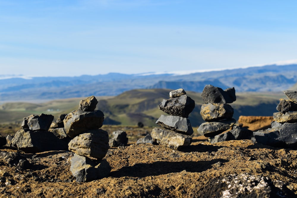 a pile of rocks sitting on top of a dirt field
