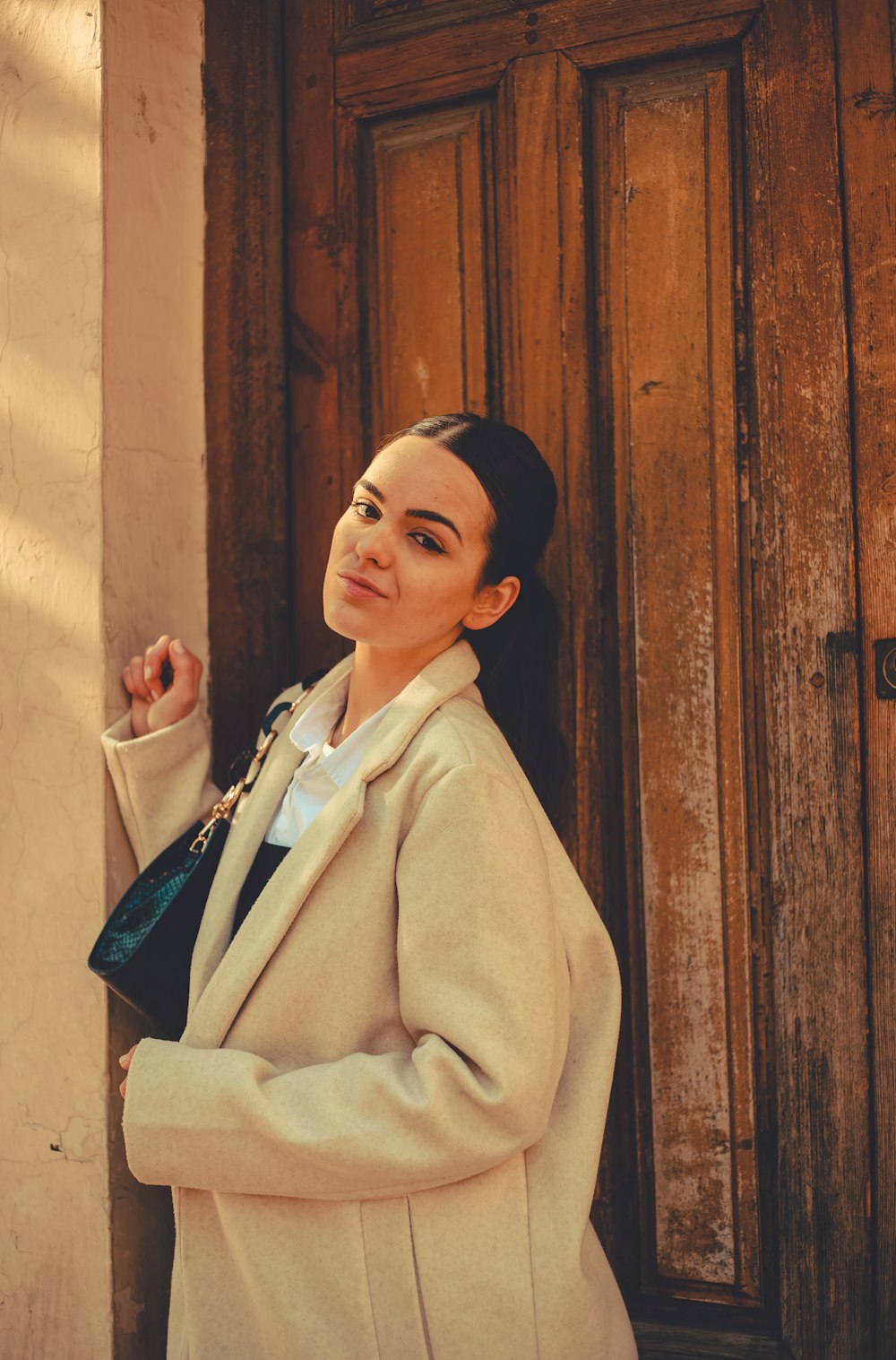 a woman standing in front of a wooden door