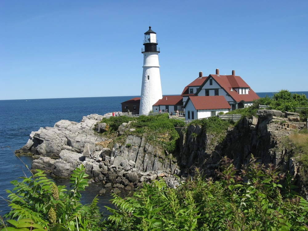 a lighthouse on a rocky cliff near the ocean
