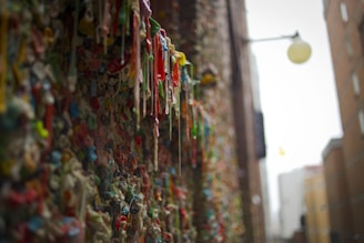 a wall covered in gummy bears next to a building