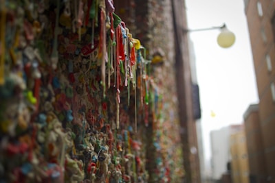 a wall covered in gummy bears next to a building