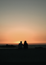A serene couple enjoying a sunset together, symbolizing love and connection.