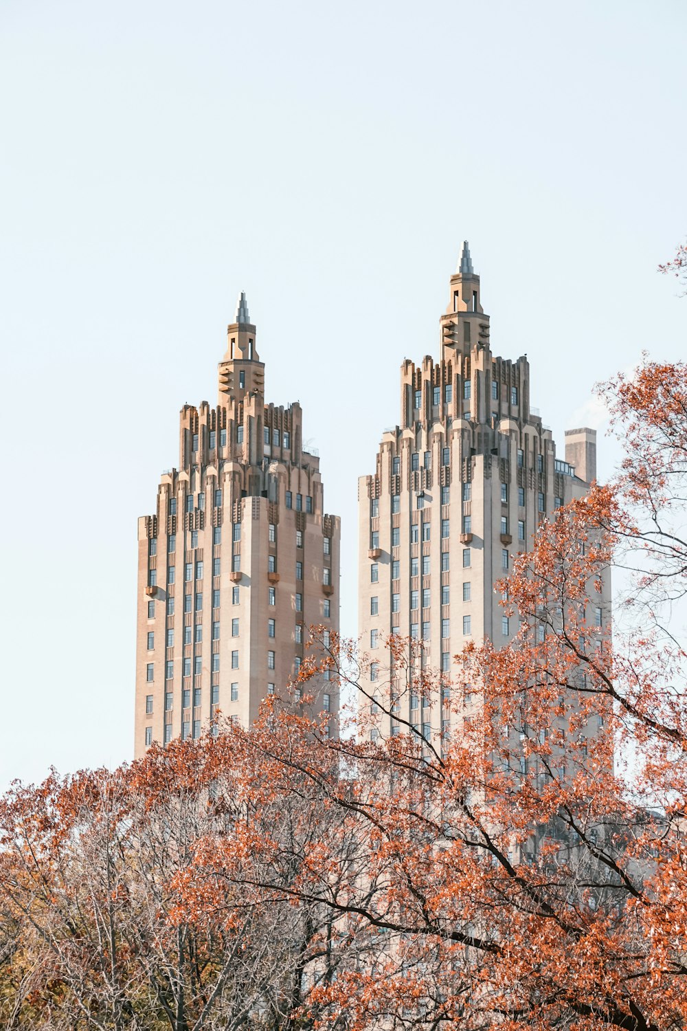 a couple of tall buildings sitting next to each other