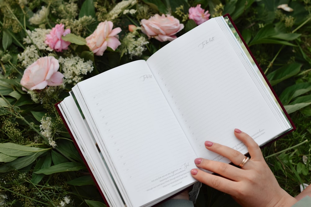 a person is holding a book in their hand