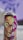 A spray can with vibrant and colorful artwork featuring a stylized human face with strong features. The face is adorned with bold colors including greens, reds, and purples, and an abstract background design complements the portrait.