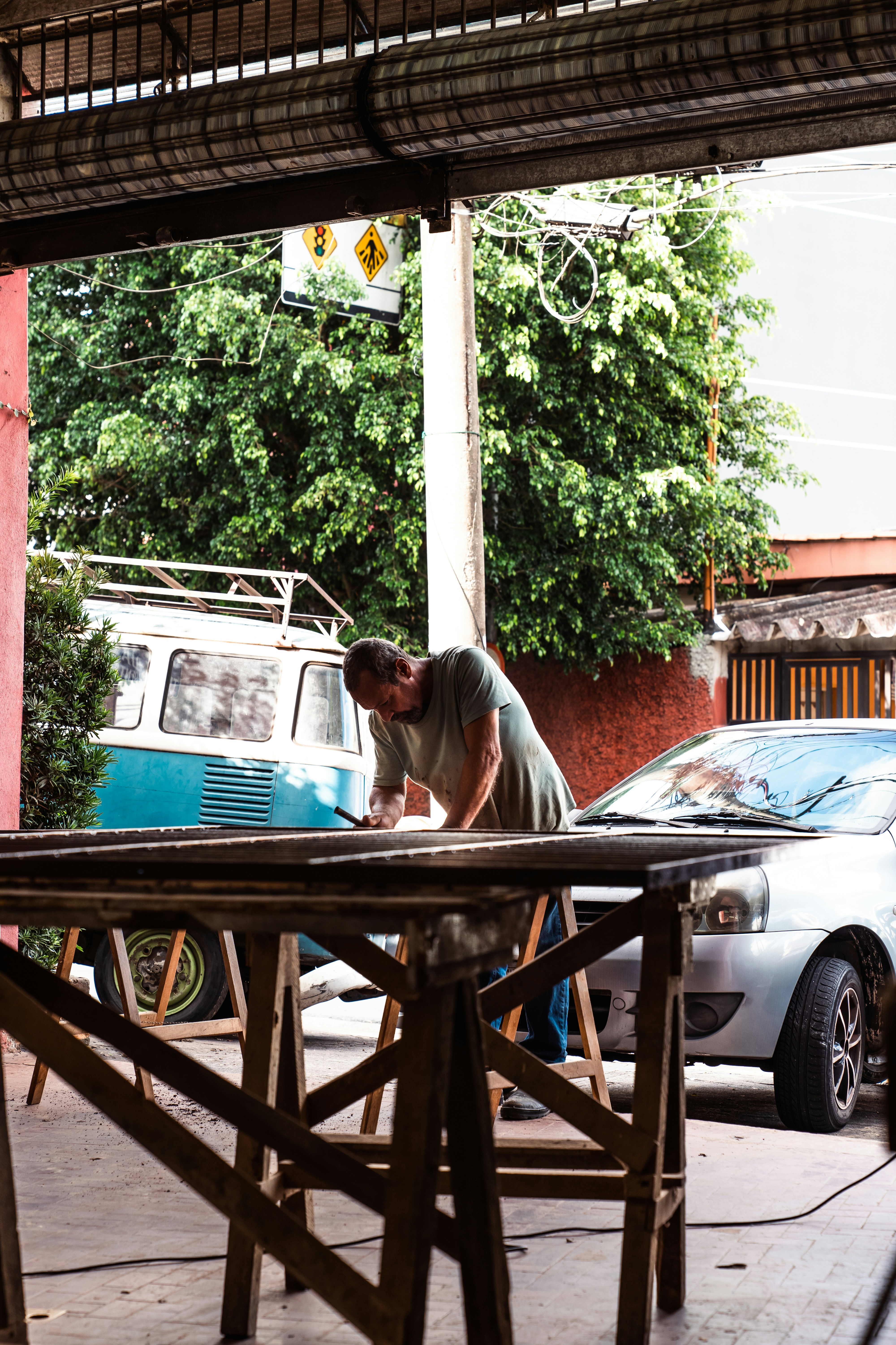 a man working on a table in front of a van