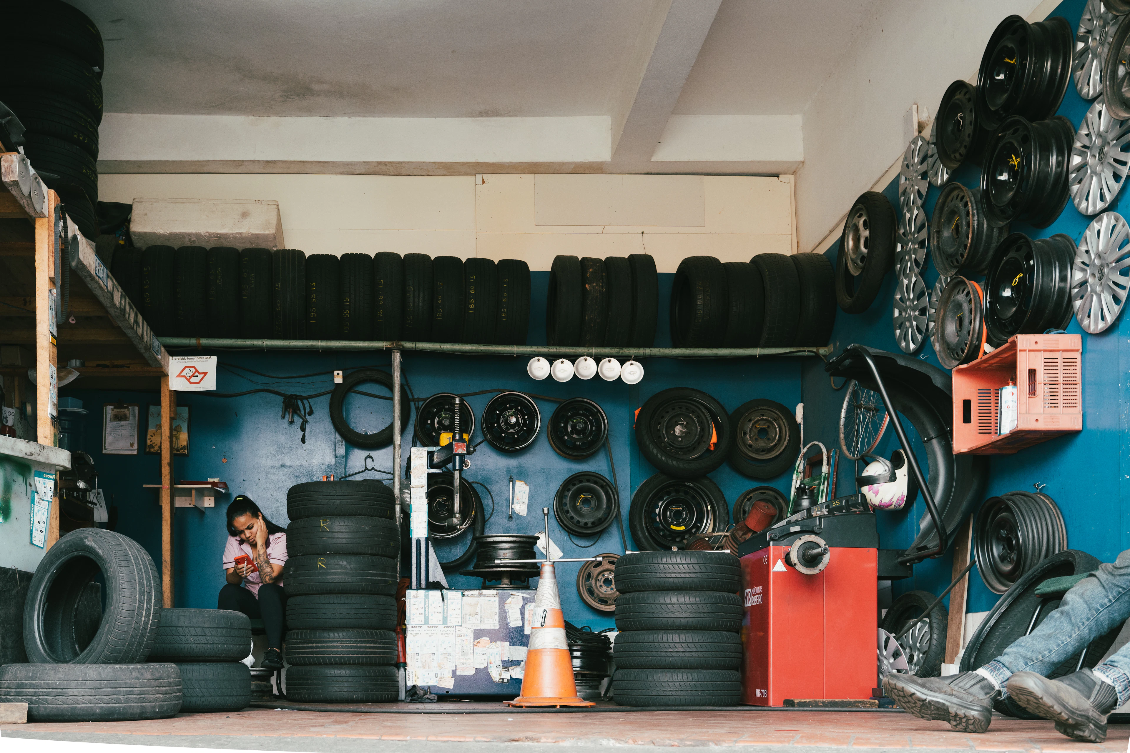 Small tire shop with tires stacked on shelves