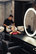 a man getting his hair cut in a salon