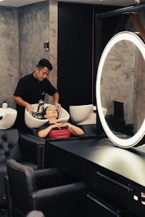 a man getting his hair cut in a salon