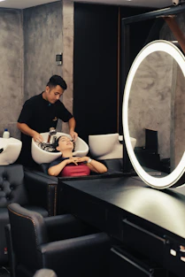 a man getting his hair cut in a salon