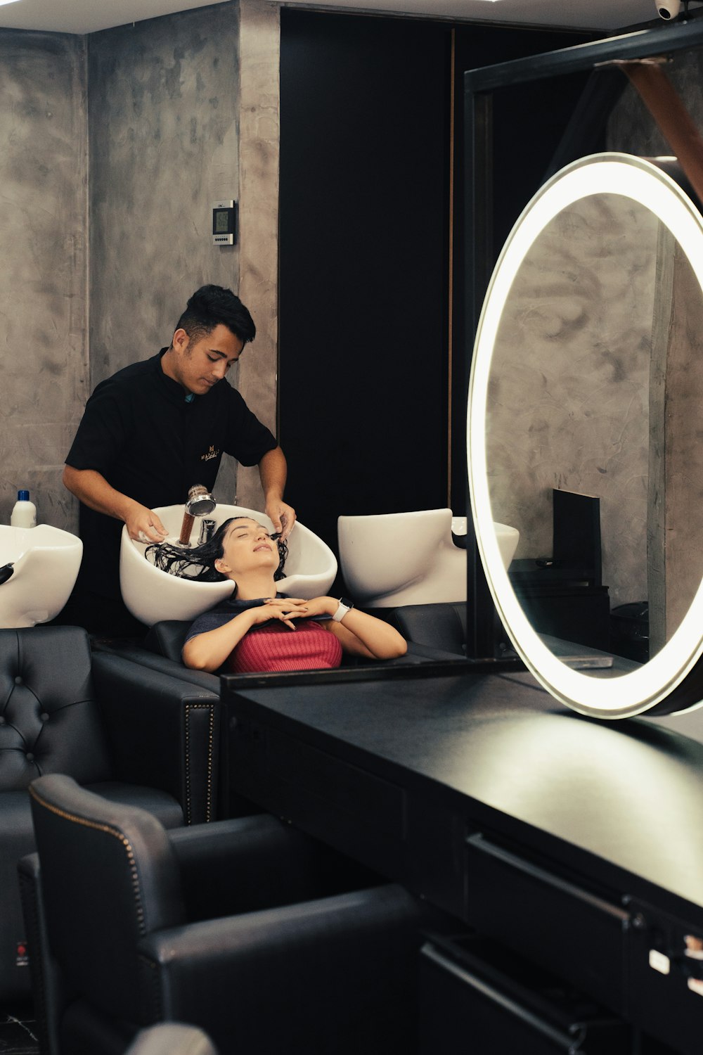 a man getting his hair cut in a salon