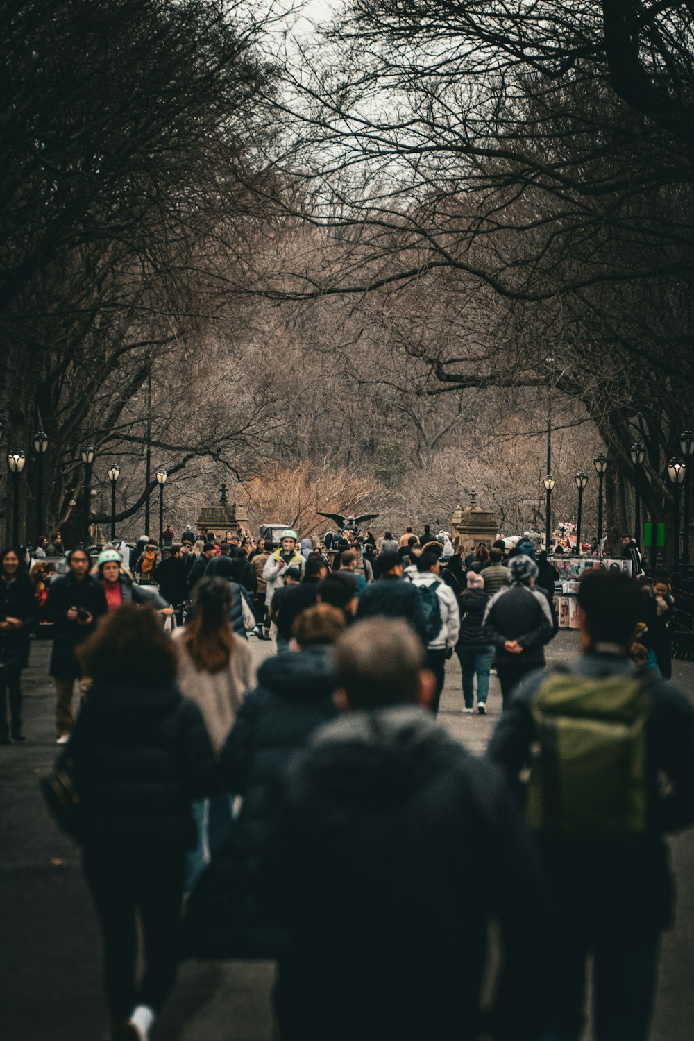 a crowd of people walking down a street