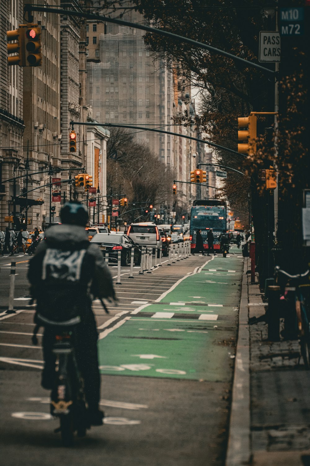 a person riding a bike on a city street