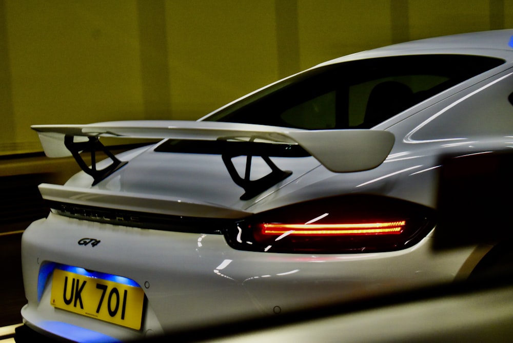 a white sports car parked in a parking lot