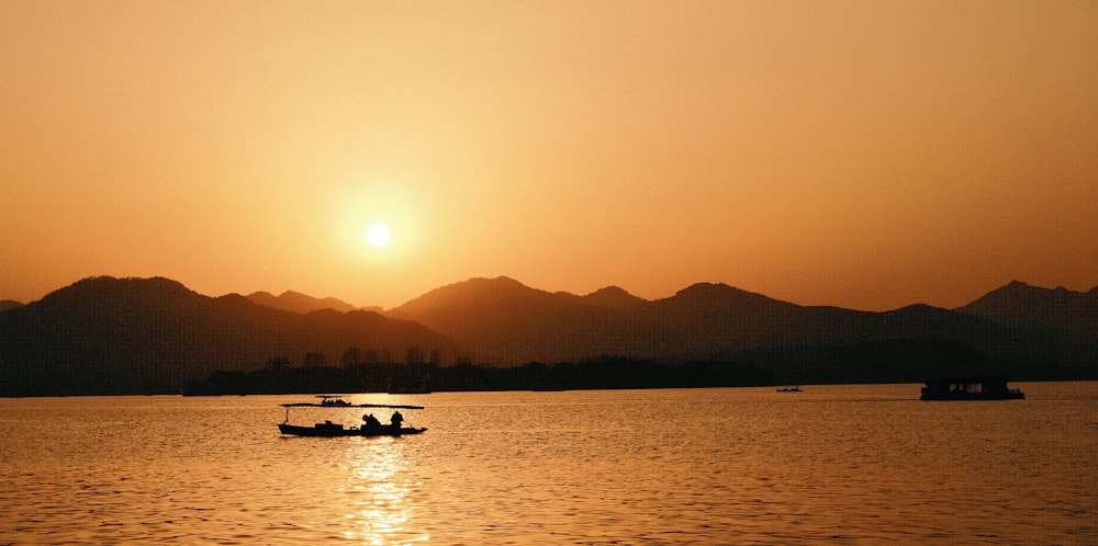 a couple of boats floating on top of a lake