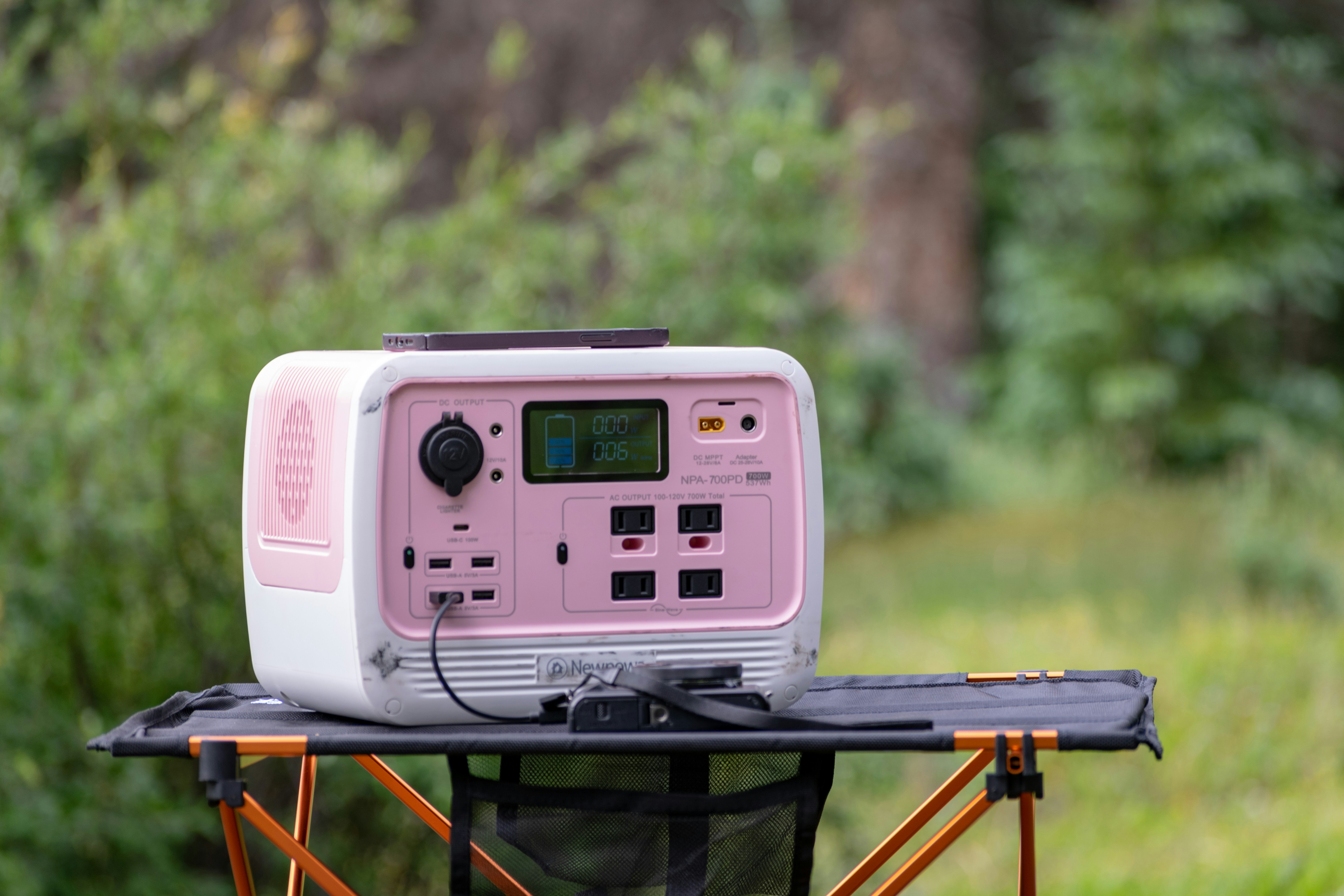 a pink and white radio sitting on top of a chair