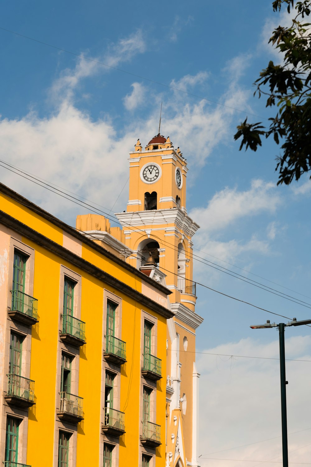 a tall yellow building with a clock tower