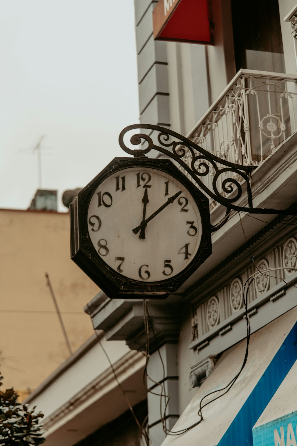 a clock hanging from the side of a building