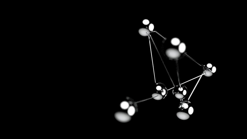 a black and white photo of a cluster of lights