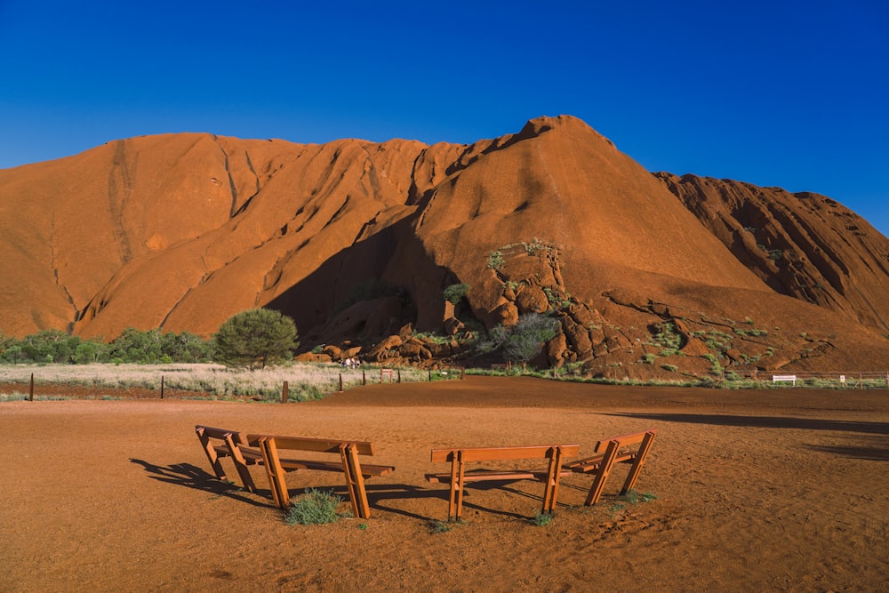 a wooden bench sitting in the middle of a desert