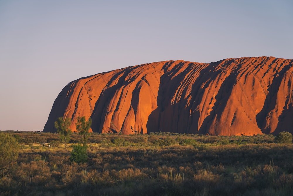 a large rock in the middle of a field