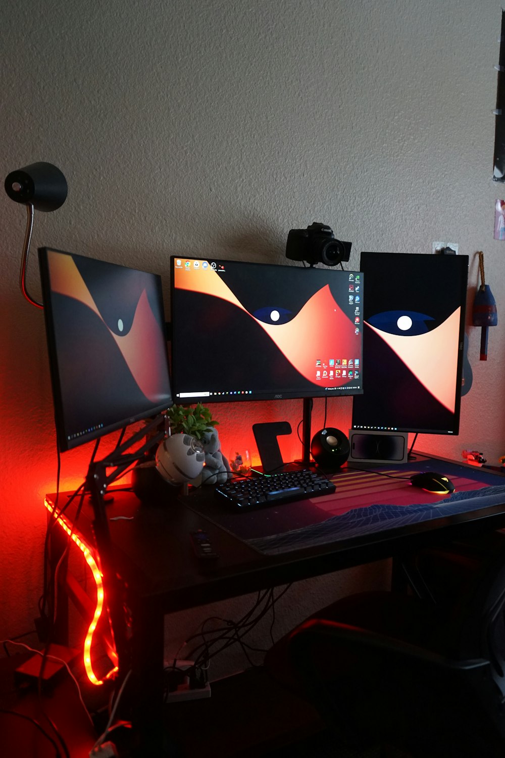 a computer desk with two monitors and a keyboard