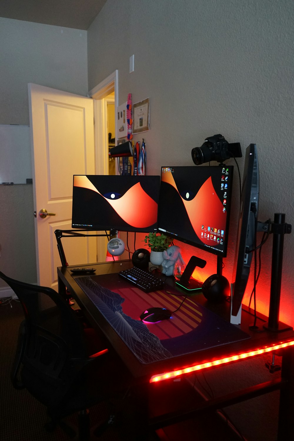 a computer desk with two monitors and a keyboard