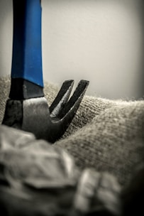 a pair of scissors are stuck in a piece of fabric