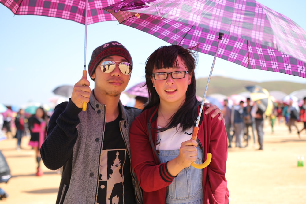 a man and a woman standing under an umbrella