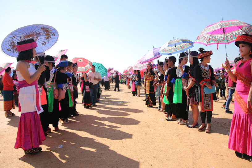 A vibrant traditional Missouria dance gathering under a clear blue sky.