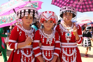 a group of young women standing next to each other under umbrellas